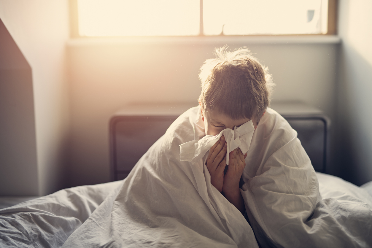 Portrait of sick little boy aged 8 lying in bed.
Nikon D850