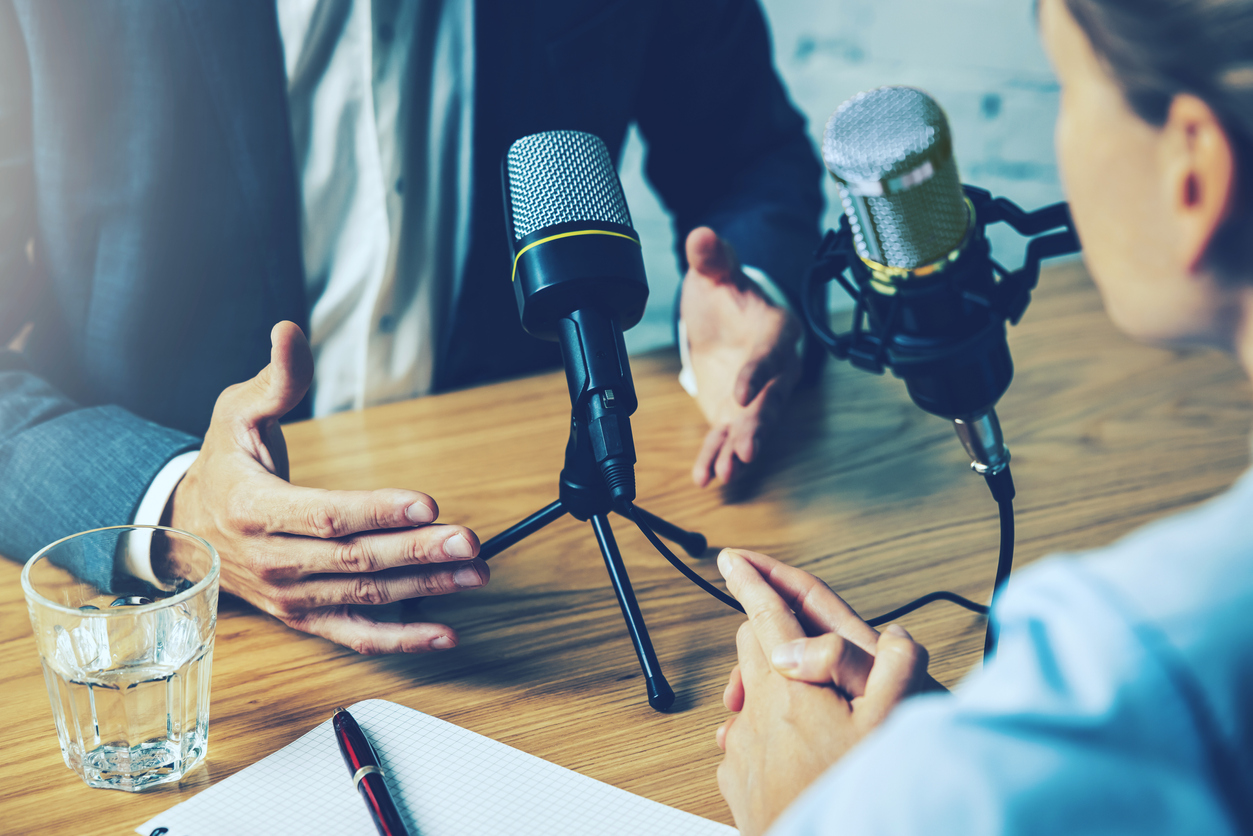 radio interview, podcast recording - business people talking in broadcasting studio